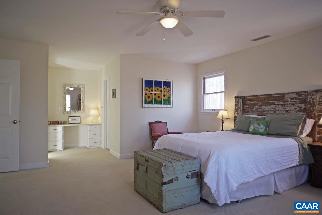 2657 Cardinal Ridge Road Charlottesville, VA 22901 - Photo 31 of 50 a bedroom with a bed and a chandelier