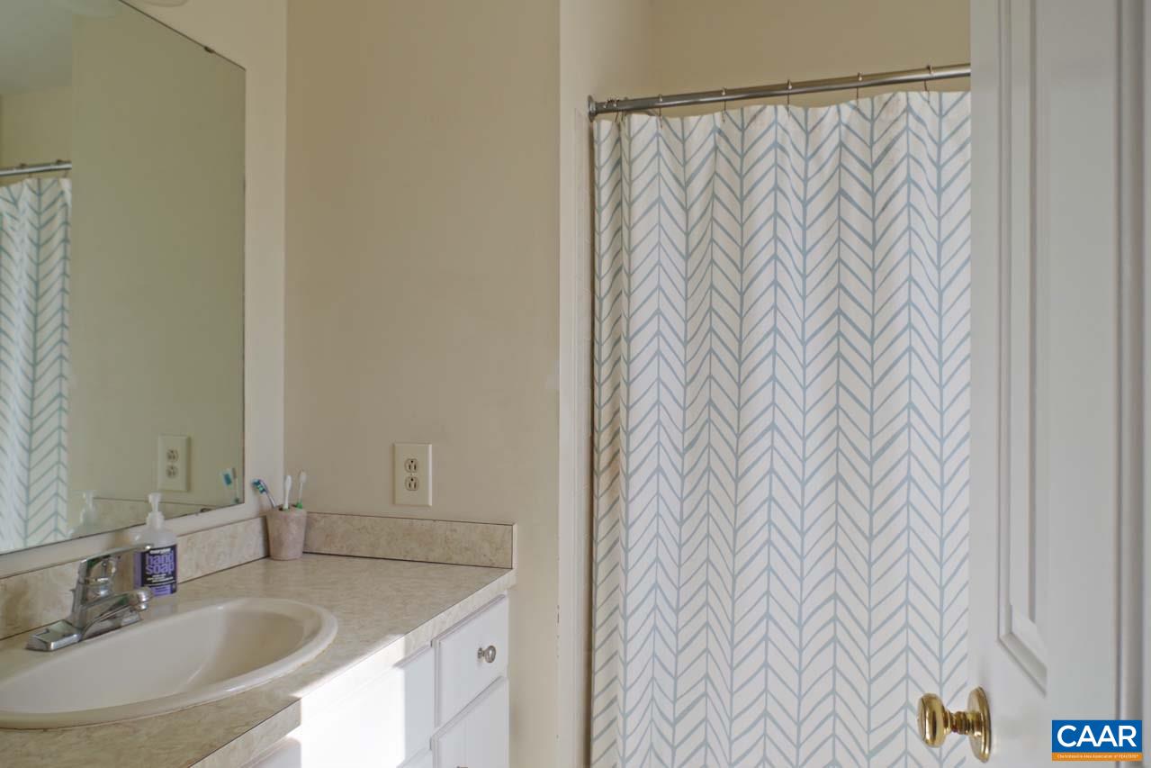 2657 Cardinal Ridge Road Charlottesville, VA 22901 - Photo 34 of 50 a bathroom with a granite countertop sink and a mirror