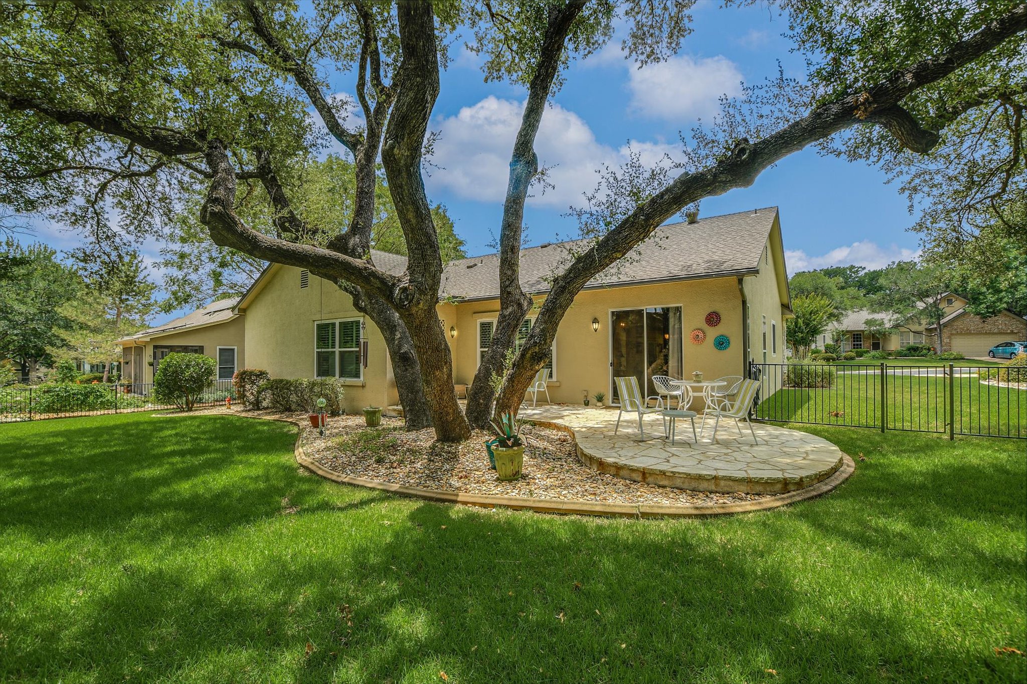 106 Nighthawk Way Georgetown, TX 78633 - Photo 26 of 29 An inviting stone patio offers a private outdoor oasis beneath the shade of mature trees.