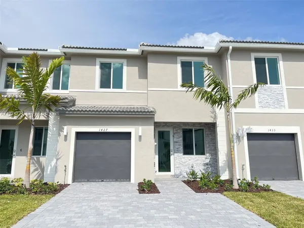 a front view of a house with yard