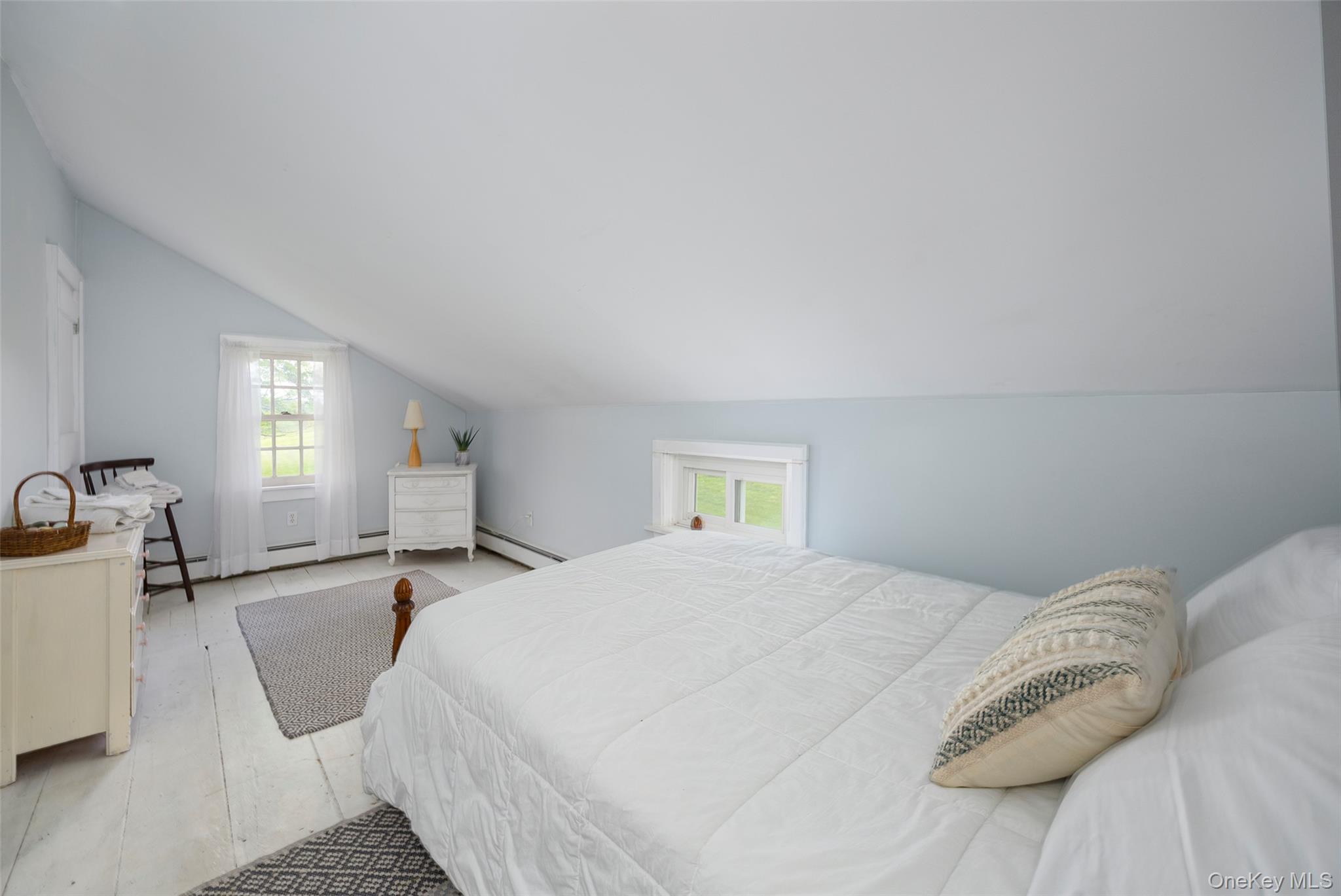 148 Creek Road Staatsburg, NY 12580 - Photo 13 of 27 Bedroom with vaulted ceiling, baseboard heating, and multiple windows
