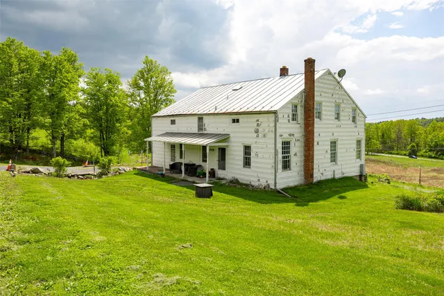 a view of a house with backyard porch and garden