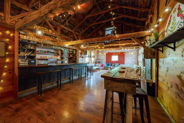 a view of a room with table and chairs