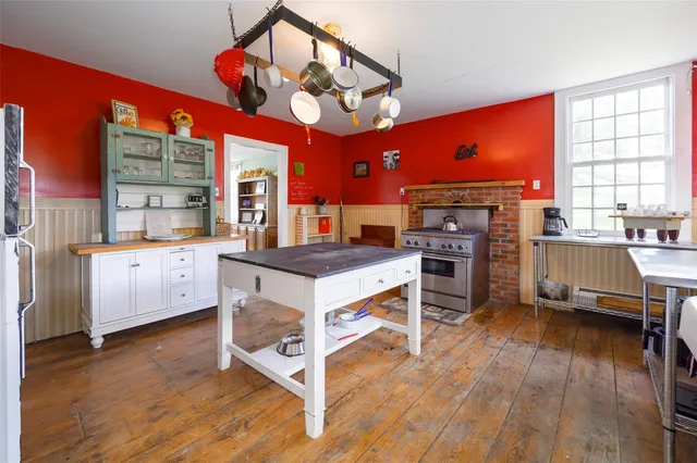 a kitchen with stainless steel appliances granite countertop a stove cabinets and wooden floor