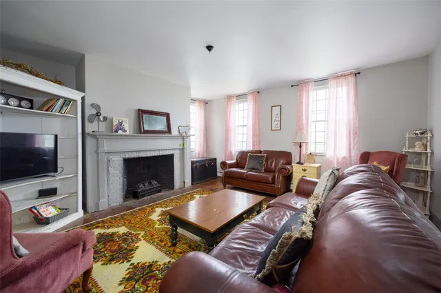 a living room with furniture a flat screen tv and a fireplace