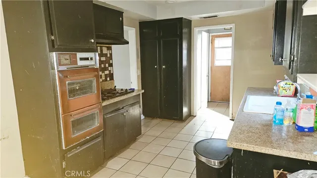 a kitchen with stainless steel appliances granite countertop a refrigerator and a stove