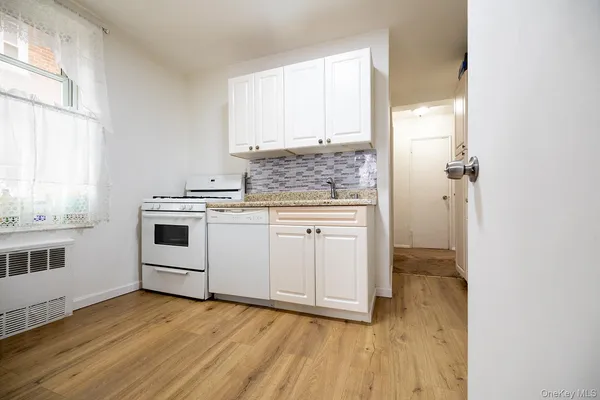 a kitchen with a stove a sink and a refrigerator