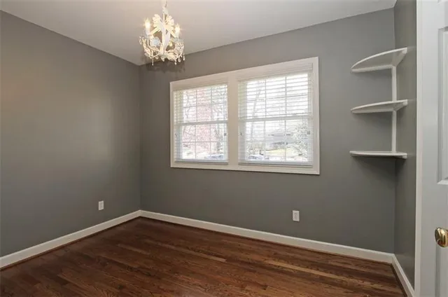 a view of wooden floor and windows in a room