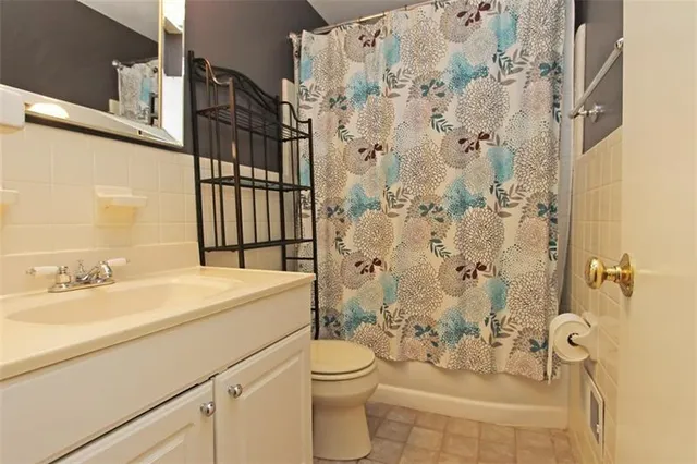 a bathroom with a sink toilet vanity and shower