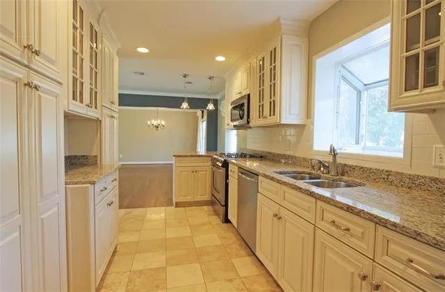 a bathroom with a granite countertop sink mirror and a bathtub