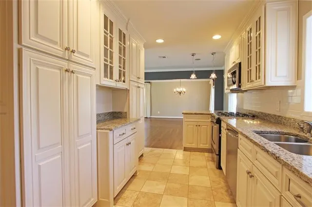 a kitchen with a sink appliances and cabinets