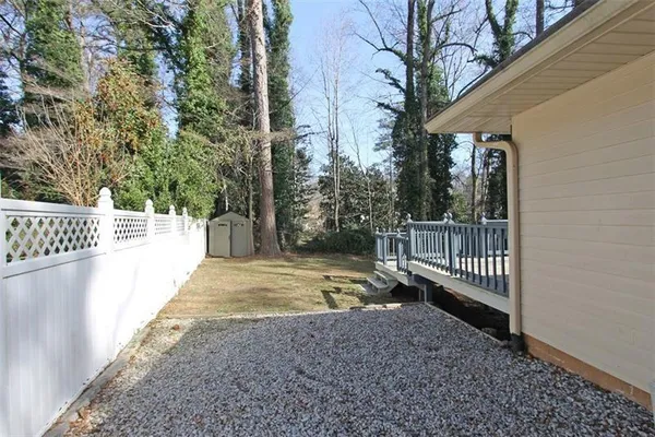 a view of a pathway with a wrought fence