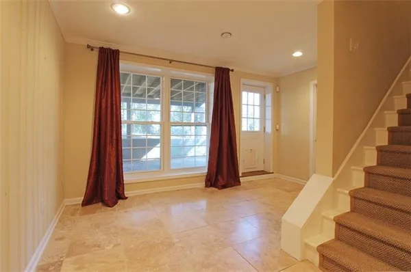 a view of an empty room with a fireplace and a window