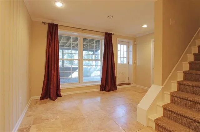 a view of an empty room with a fireplace and a window