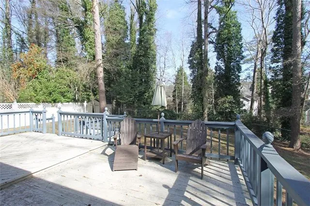 a view of balcony with outdoor seating and trees