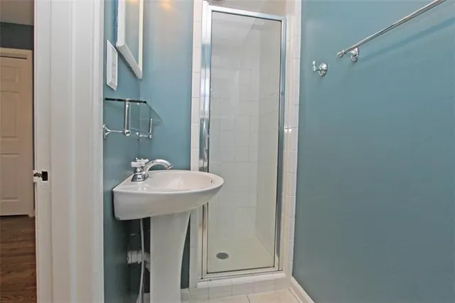 a bathroom with a sink a mirror and a shower
