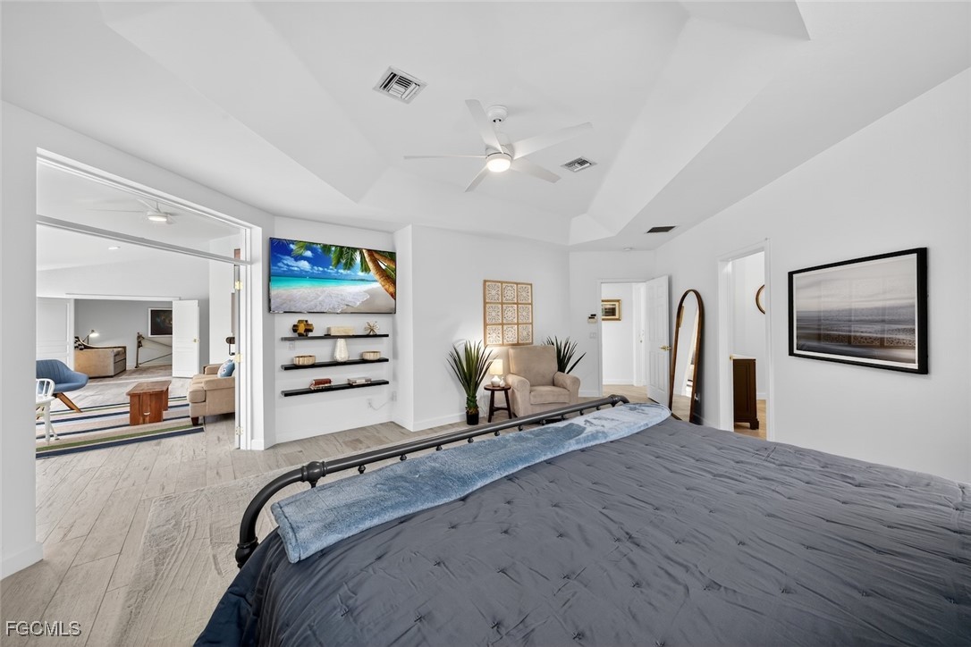 13570 Harbour Ridge Drive Fort Myers, FL 33908 - Photo 25 of 50 a bedroom with a bed and a large mirror