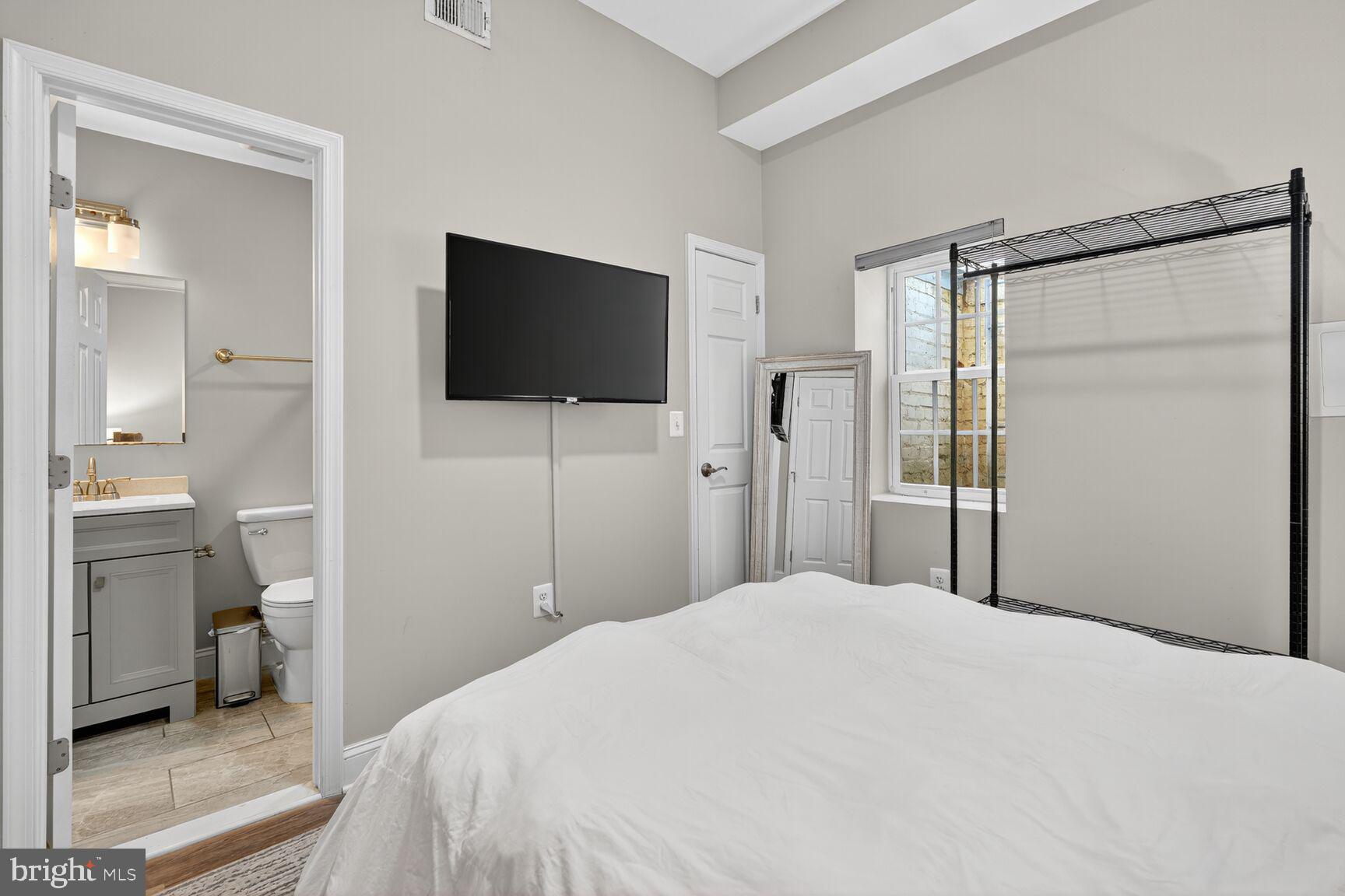 133 7th Street Southeast, Unit 3 Washington, DC 20003 - Photo 13 of 19 a bedroom with a bed and a flat screen tv