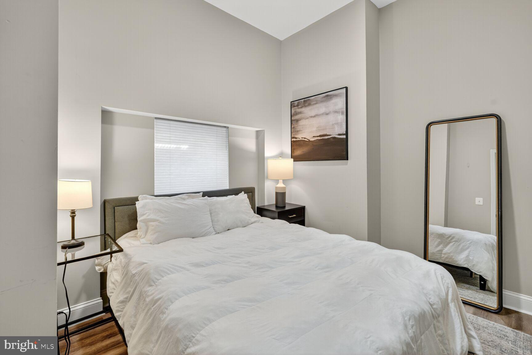 133 7th Street Southeast, Unit 3 Washington, DC 20003 - Photo 15 of 19 a bedroom with a bed and a night lamp