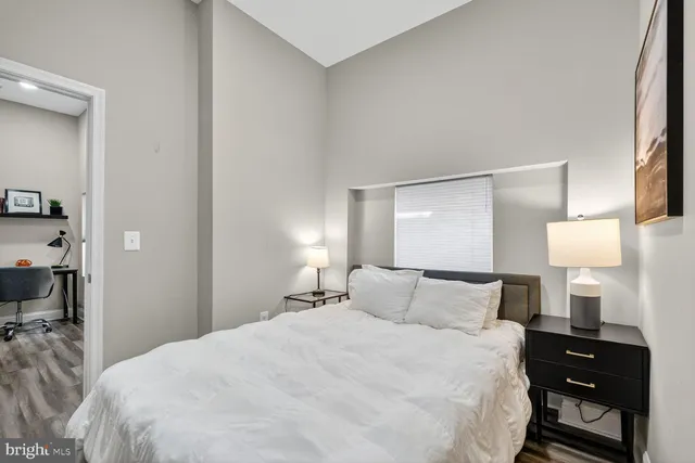 a bedroom with a bed and a night lamp