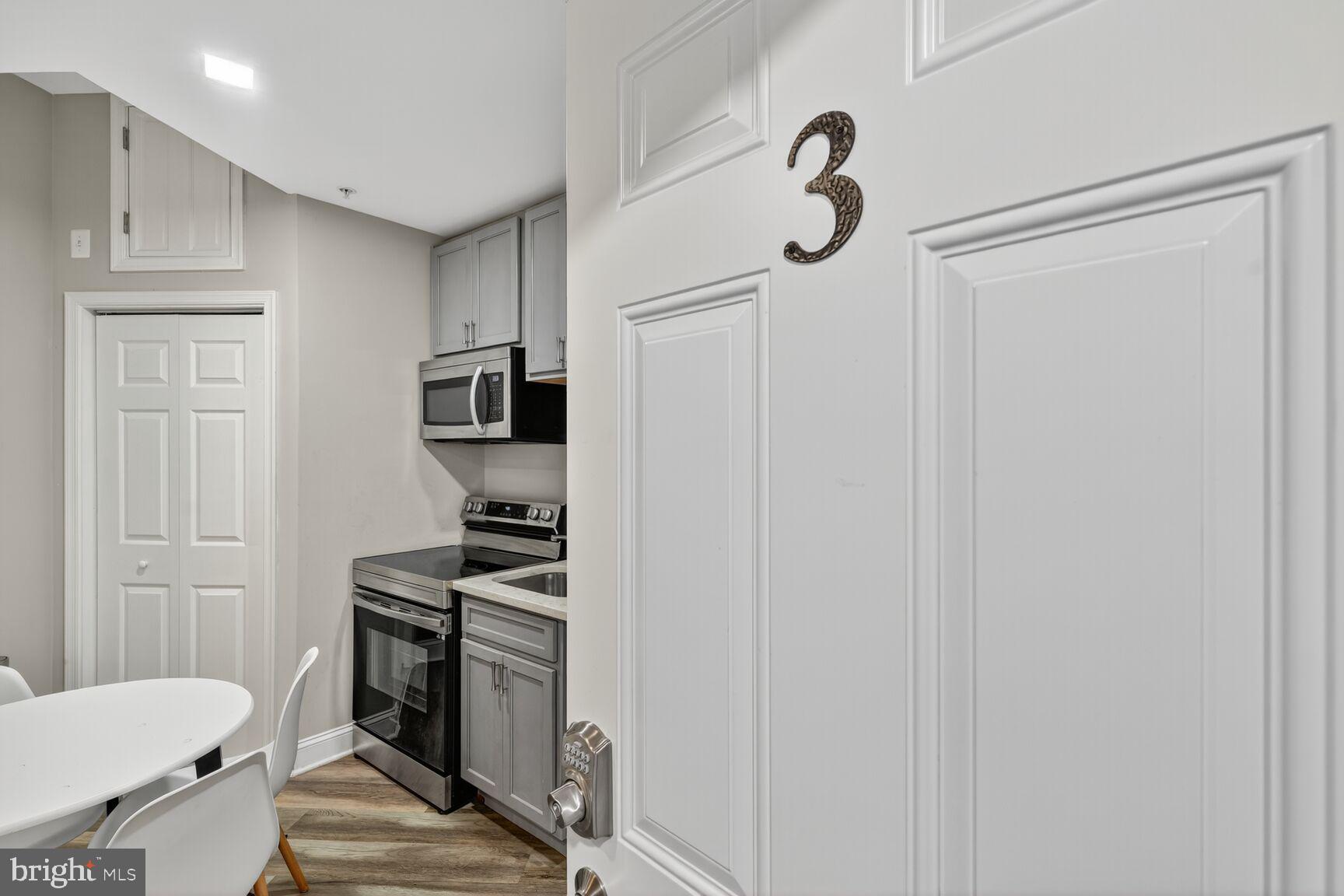133 7th Street Southeast, Unit 3 Washington, DC 20003 - Photo 4 of 19 a kitchen with stainless steel appliances a refrigerator and a stove top oven