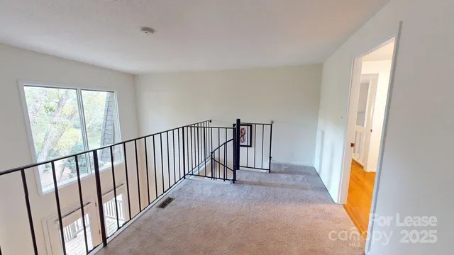 a view of a hallway with wooden floor and entryway
