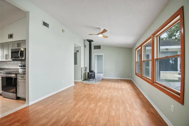 a kitchen with stainless steel appliances granite countertop a sink dishwasher a stove top oven a refrigerator with island and cabinets