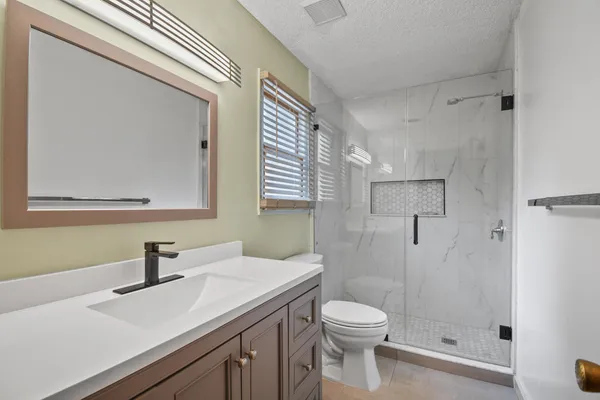 a bathroom with a toilet and shower