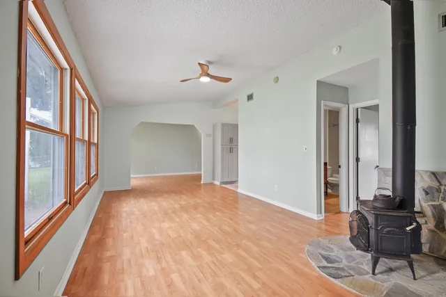a view of a room with wooden floor and a window