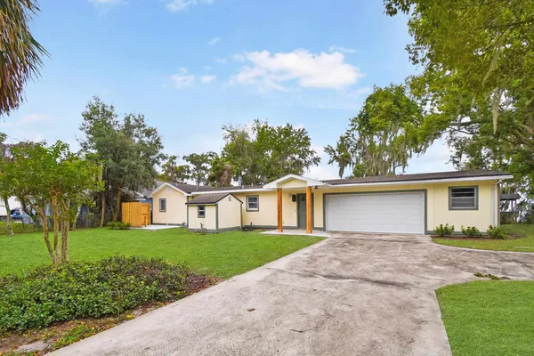 a front view of house with yard and green space
