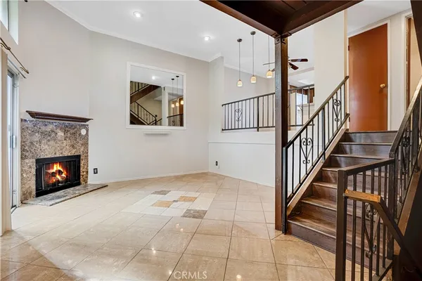 a view of an entryway and livingroom with fireplace