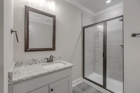 a bathroom with a granite countertop sink mirror and vanity