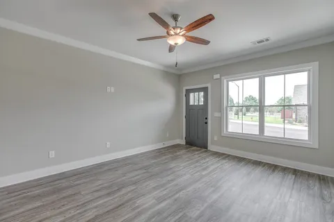 wooden floor in an empty room with a window
