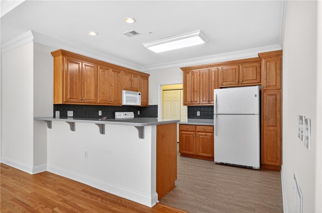 226 Hames Road, Unit 140 Woodstock, GA 30188 - Photo 13 of 32 a kitchen with a refrigerator sink and cabinets