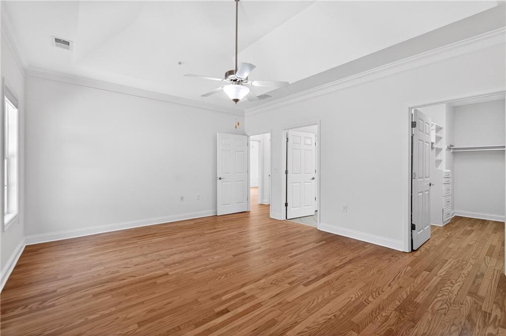 226 Hames Road, Unit 140 Woodstock, GA 30188 - Photo 16 of 32 an empty room with wooden floor and ceiling fan