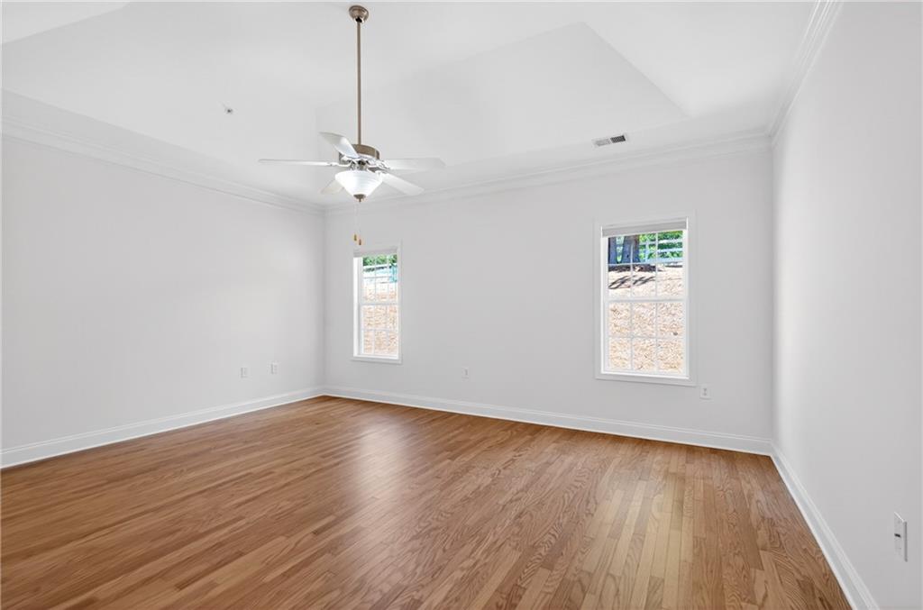 226 Hames Road, Unit 140 Woodstock, GA 30188 - Photo 17 of 32 a view of an empty room with wooden floor and a window