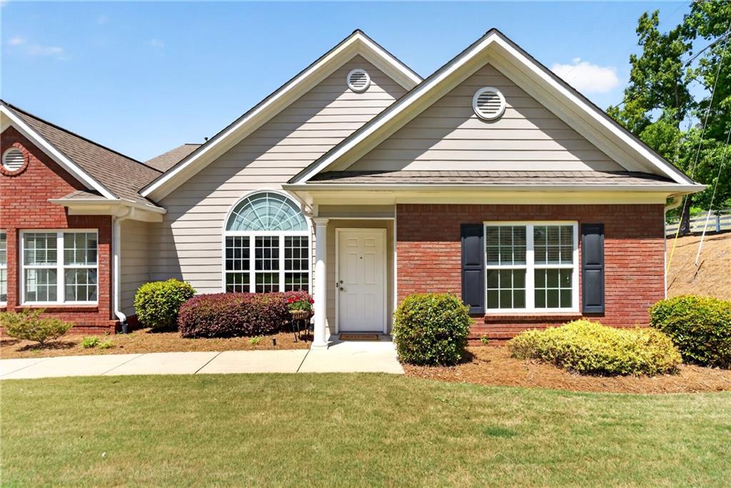 226 Hames Road, Unit 140 Woodstock, GA 30188 - Photo 2 of 32 a front view of a house with garden