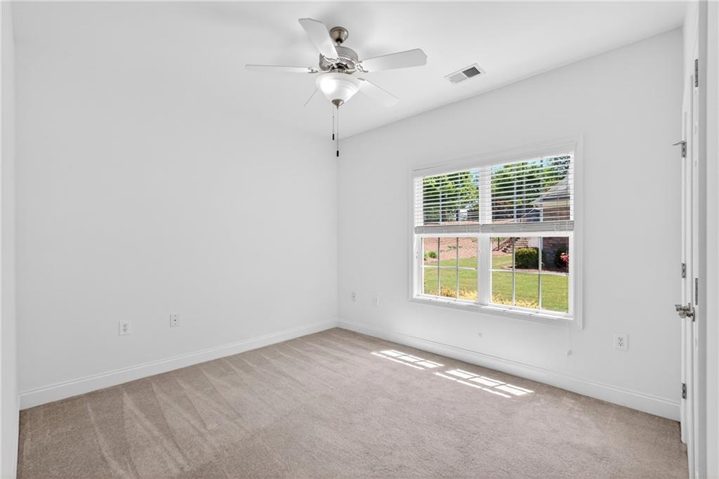 226 Hames Road, Unit 140 Woodstock, GA 30188 - Photo 22 of 32 an empty room with windows and fan