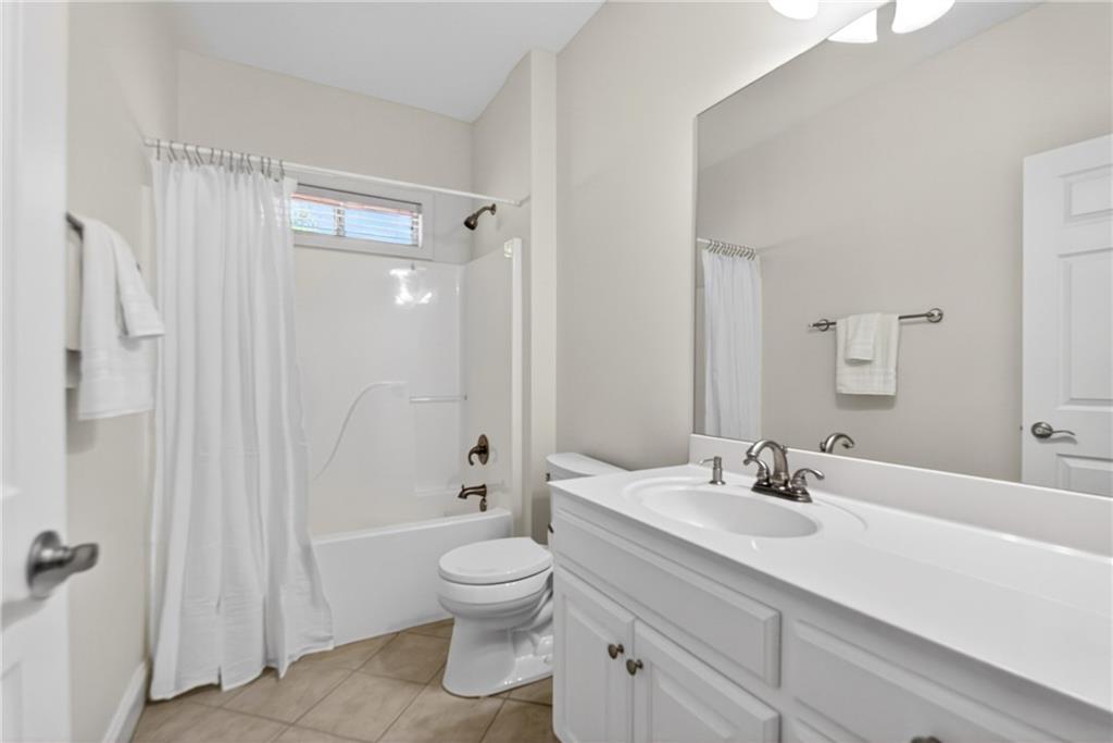226 Hames Road, Unit 140 Woodstock, GA 30188 - Photo 23 of 32 a bathroom with a sink a toilet and shower