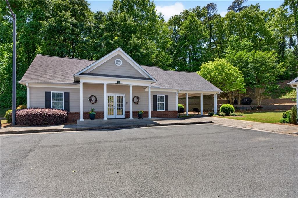 226 Hames Road, Unit 140 Woodstock, GA 30188 - Photo 28 of 32 a front view of a house with a yard and garage