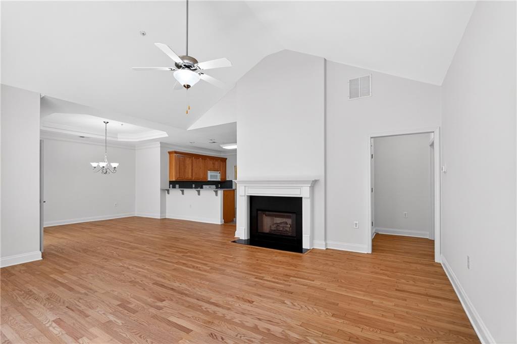 226 Hames Road, Unit 140 Woodstock, GA 30188 - Photo 5 of 32 a view of an empty room with a fireplace and a window