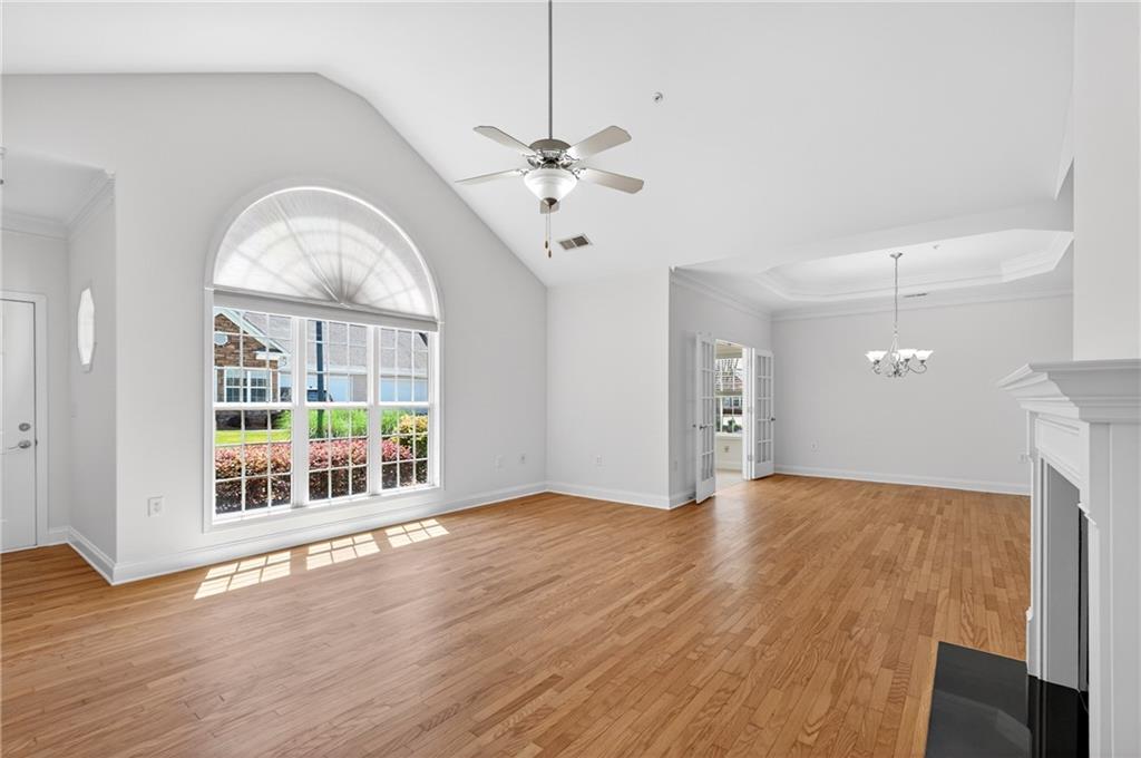 226 Hames Road, Unit 140 Woodstock, GA 30188 - Photo 7 of 32 a view of an empty room with a window and wooden floor