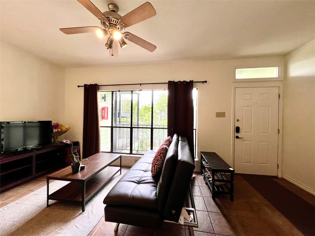 915 West 22nd 1/2 Street, Unit 203 Austin, TX 78721 - Photo 8 of 12 a living room with furniture and a flat screen tv