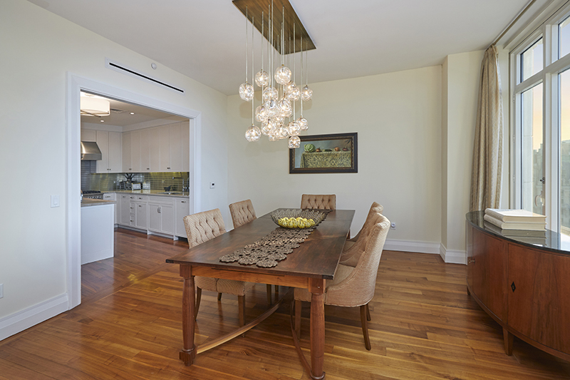 2150 Broadway, Unit PH2B Manhattan, NY 10023 - Photo 14 of 35 a view of a dining room with furniture a chandelier and wooden floor