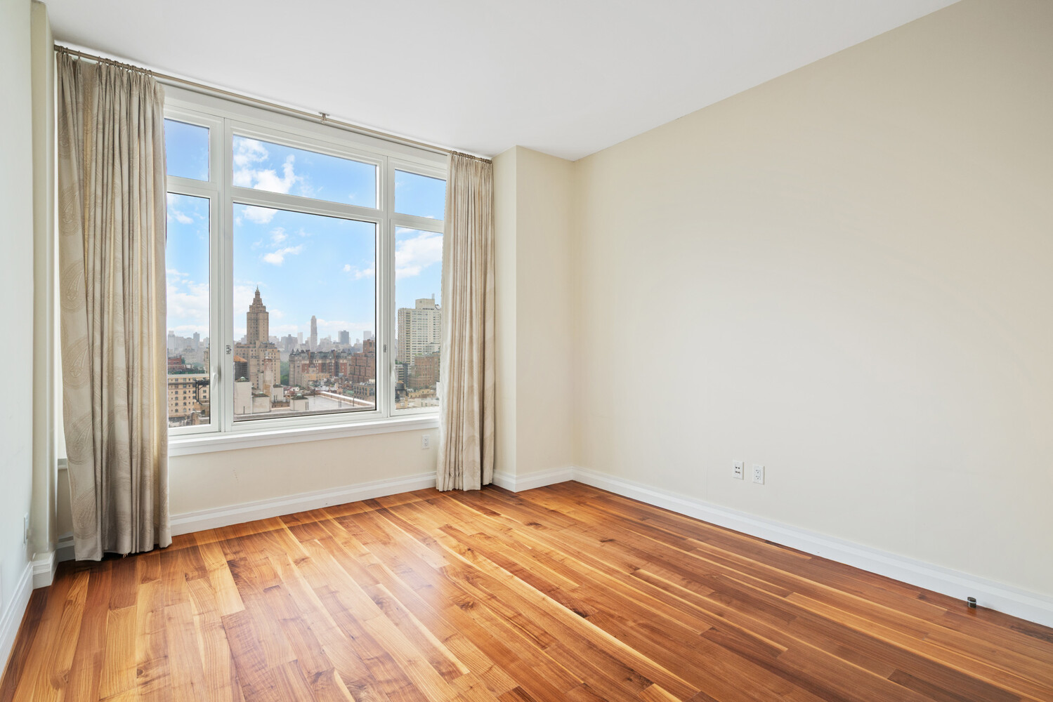 2150 Broadway, Unit PH2B Manhattan, NY 10023 - Photo 15 of 35 a view of empty room with wooden floor and fan
