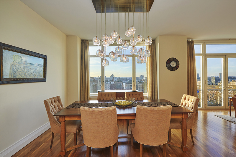 2150 Broadway, Unit PH2B Manhattan, NY 10023 - Photo 30 of 35 a dining room with furniture a large window and wooden floor