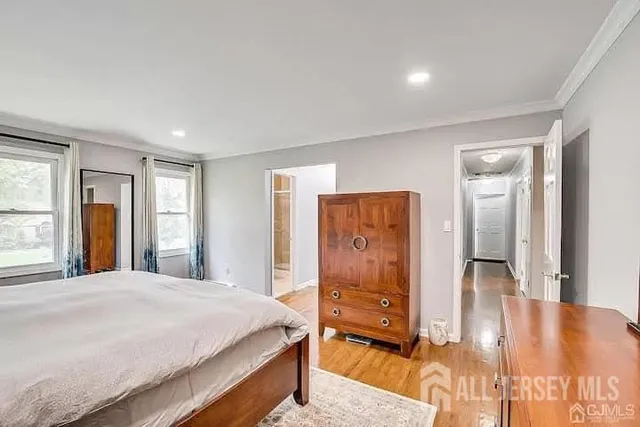 a spacious bedroom with a bed and a dresser