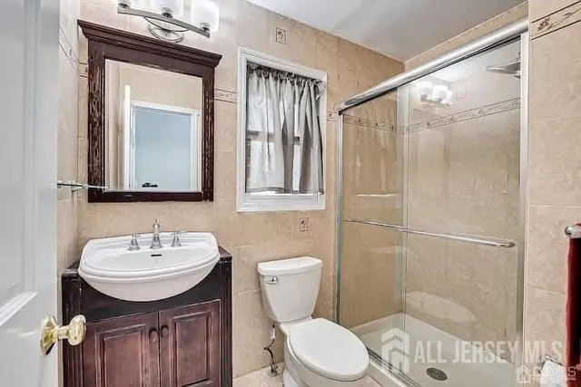 a bathroom with a toilet sink shower and mirror