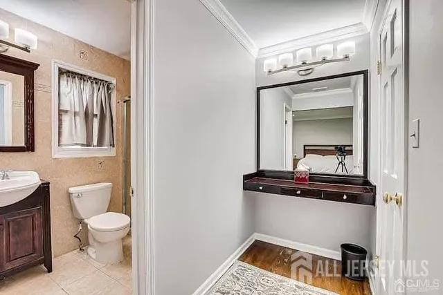 a bathroom with a toilet a sink and mirror