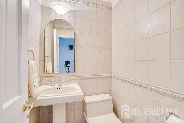 a bathroom with a sink toilet and mirror